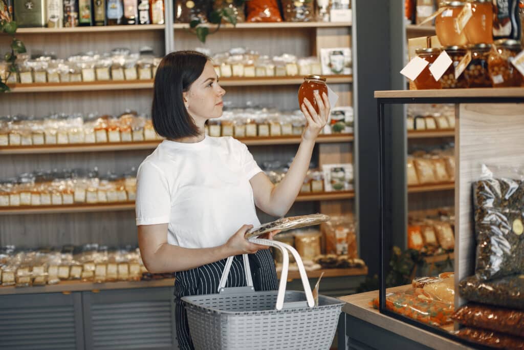 Beautiful woman in the store buys groceries.